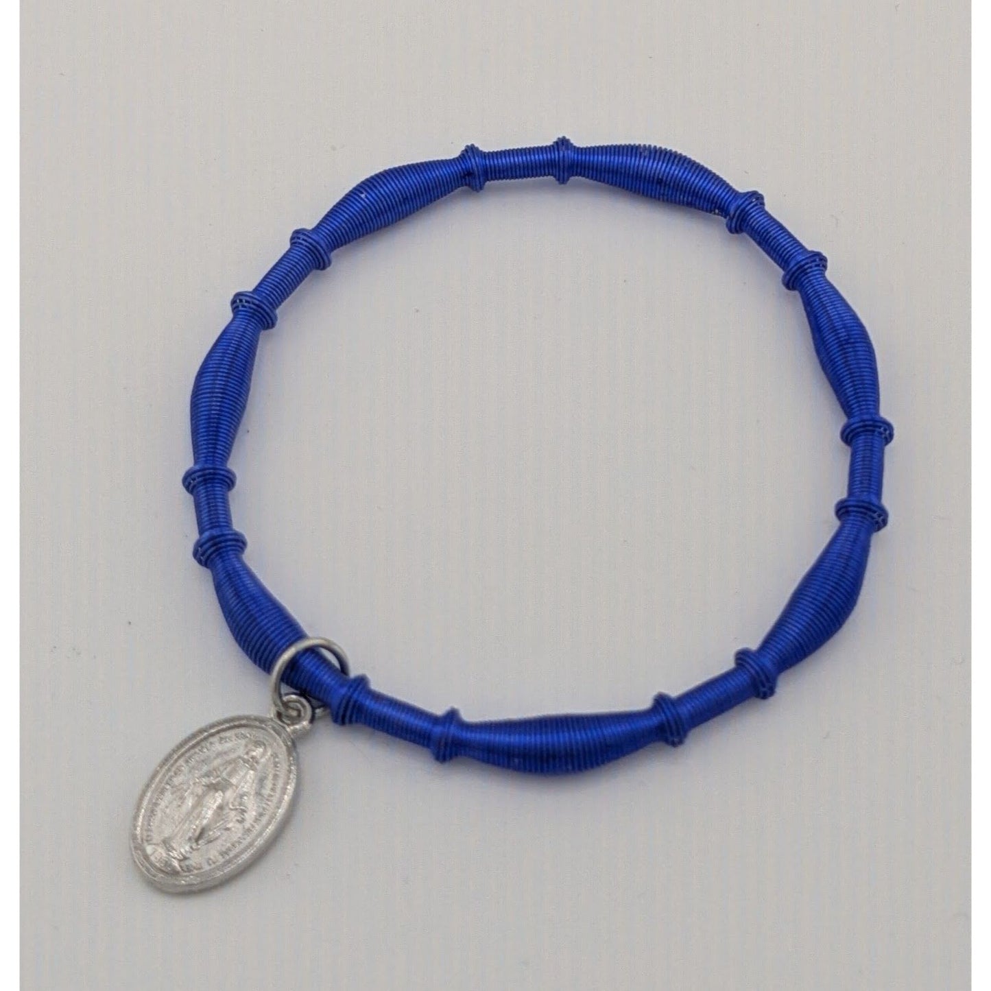 Religious Miraculous Medal Charm Bracelet On Blue Coiled Wire
