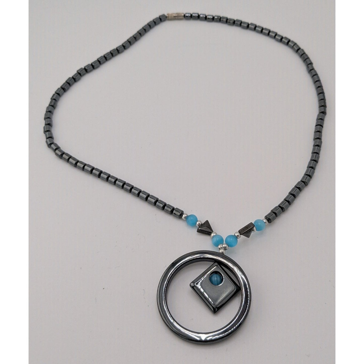 Hematite Geometric Beaded Pendant Necklace With Blue Cateye Glass Accents