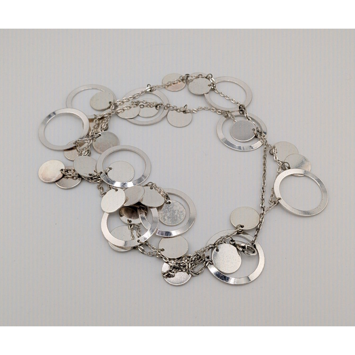 Vintage Glam Silver Tone Disc And Charm Necklace On Opera Length Chain