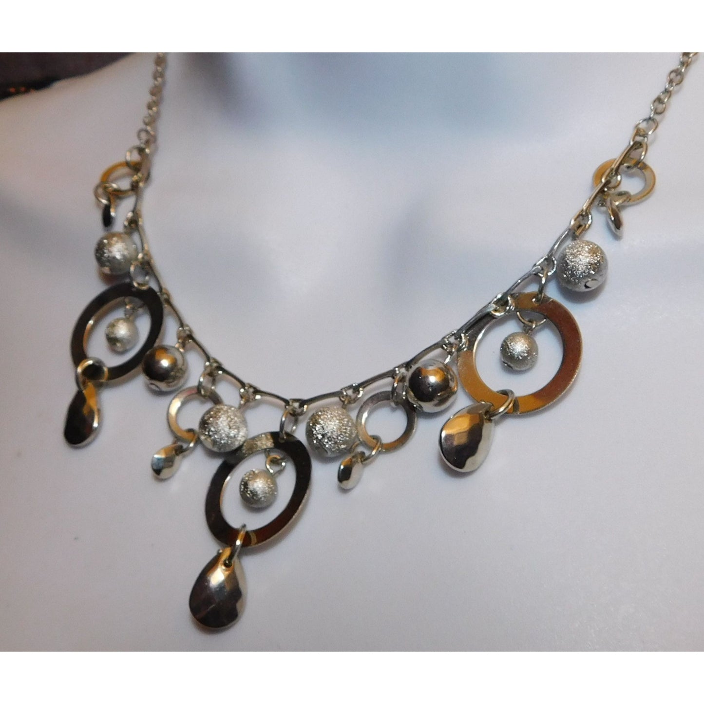 Whimsical Hoop And Charm Silver Tone Necklace