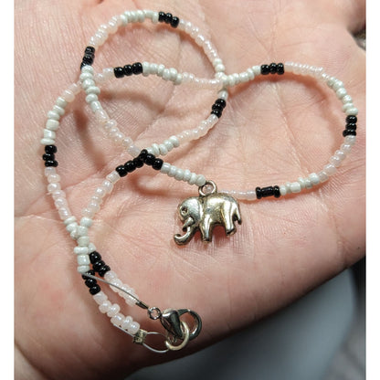 90s Bohemian Black And White Glass Beaded Necklace With Silver Tone Elephant Charm