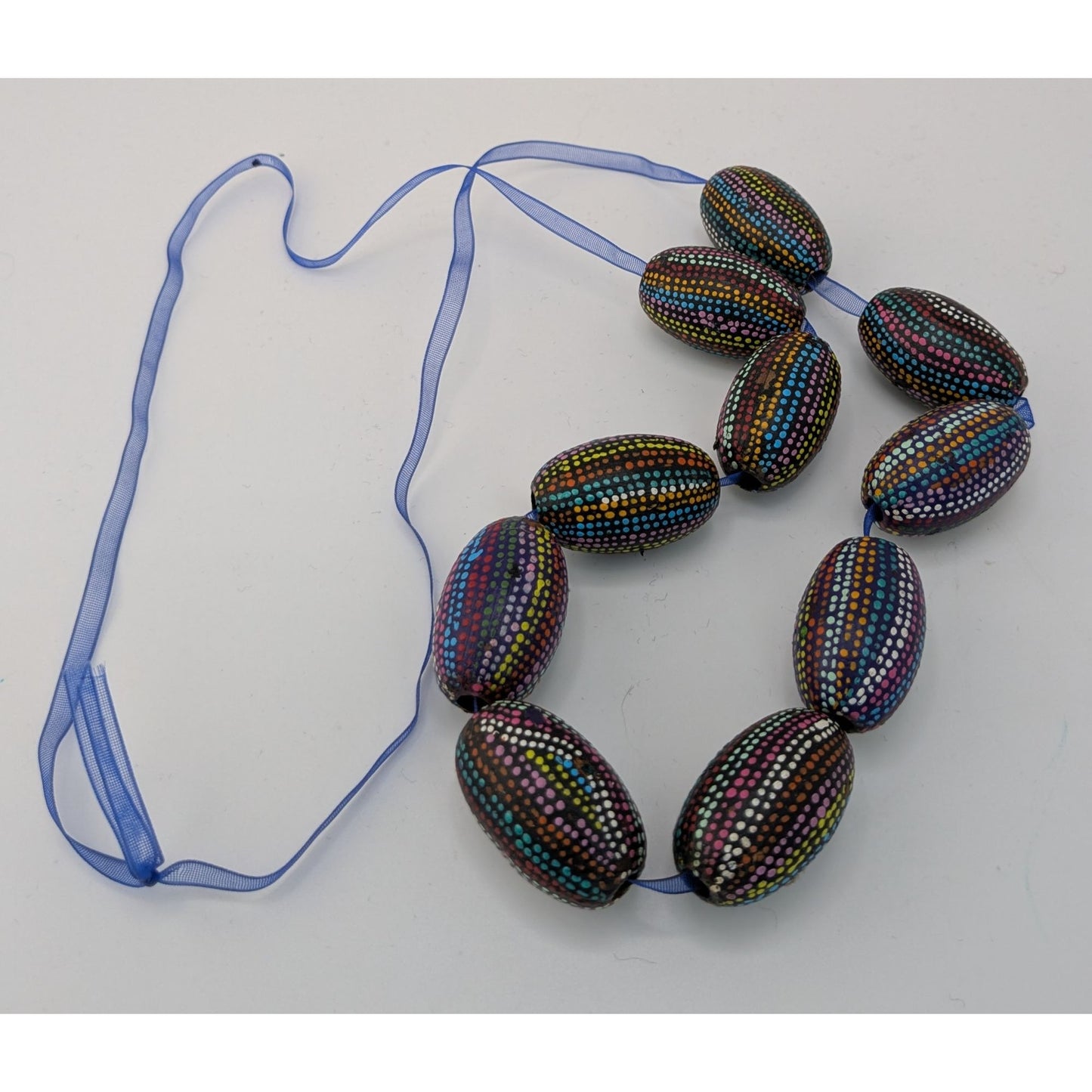 Handmade Nature Themed Necklace With Rainbow Painted Seeds & Blue Ribbon