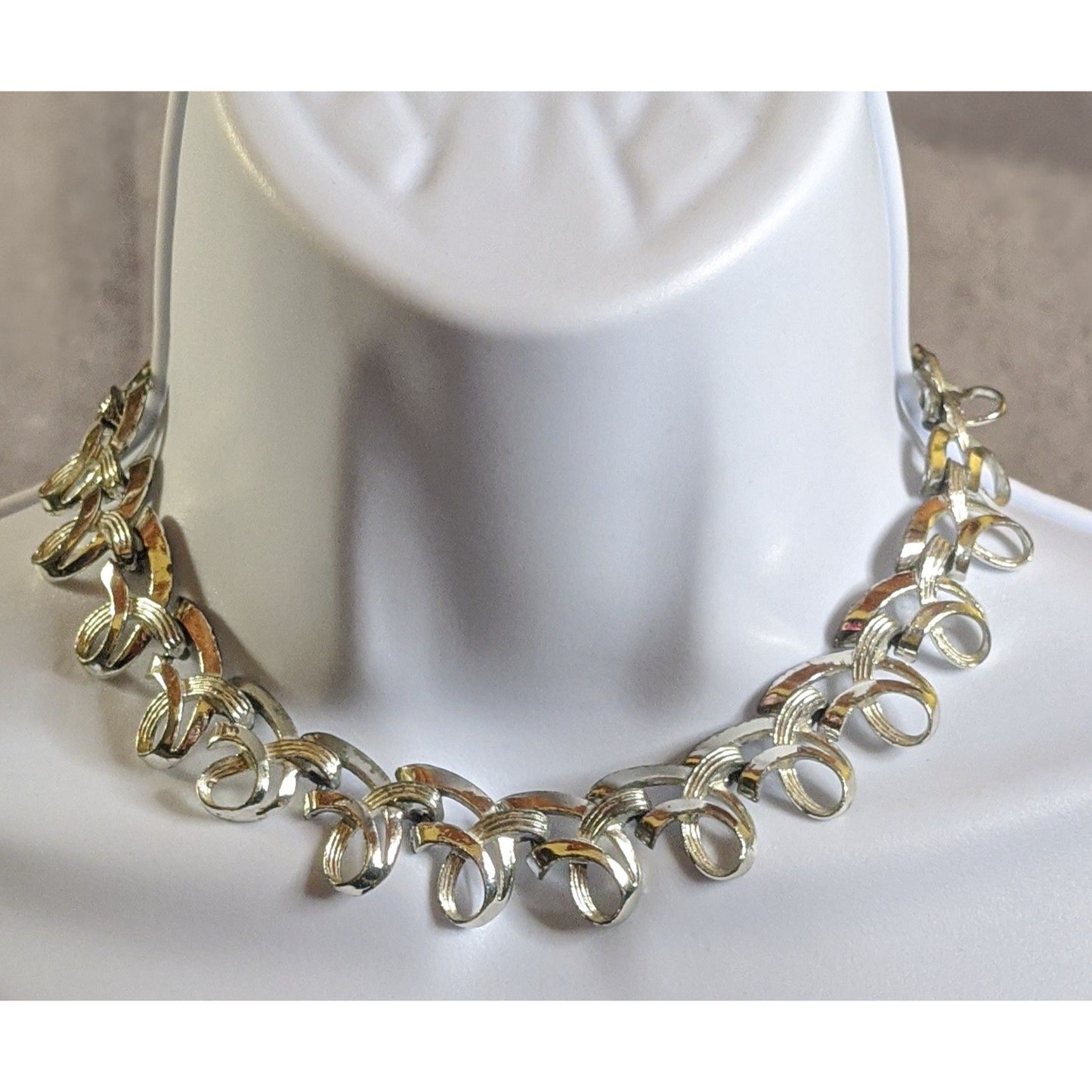 Vintage Ribbon Swirl Silver-Tone Statement Necklace With Elegant Interwoven Loops Design