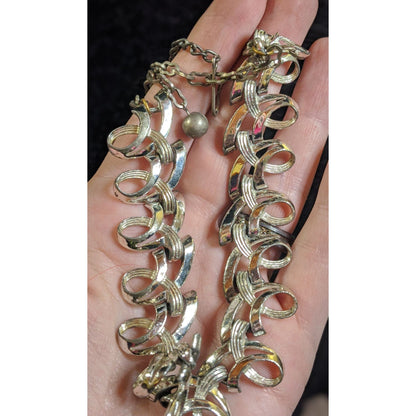 Vintage Ribbon Swirl Silver-Tone Statement Necklace With Elegant Interwoven Loops Design