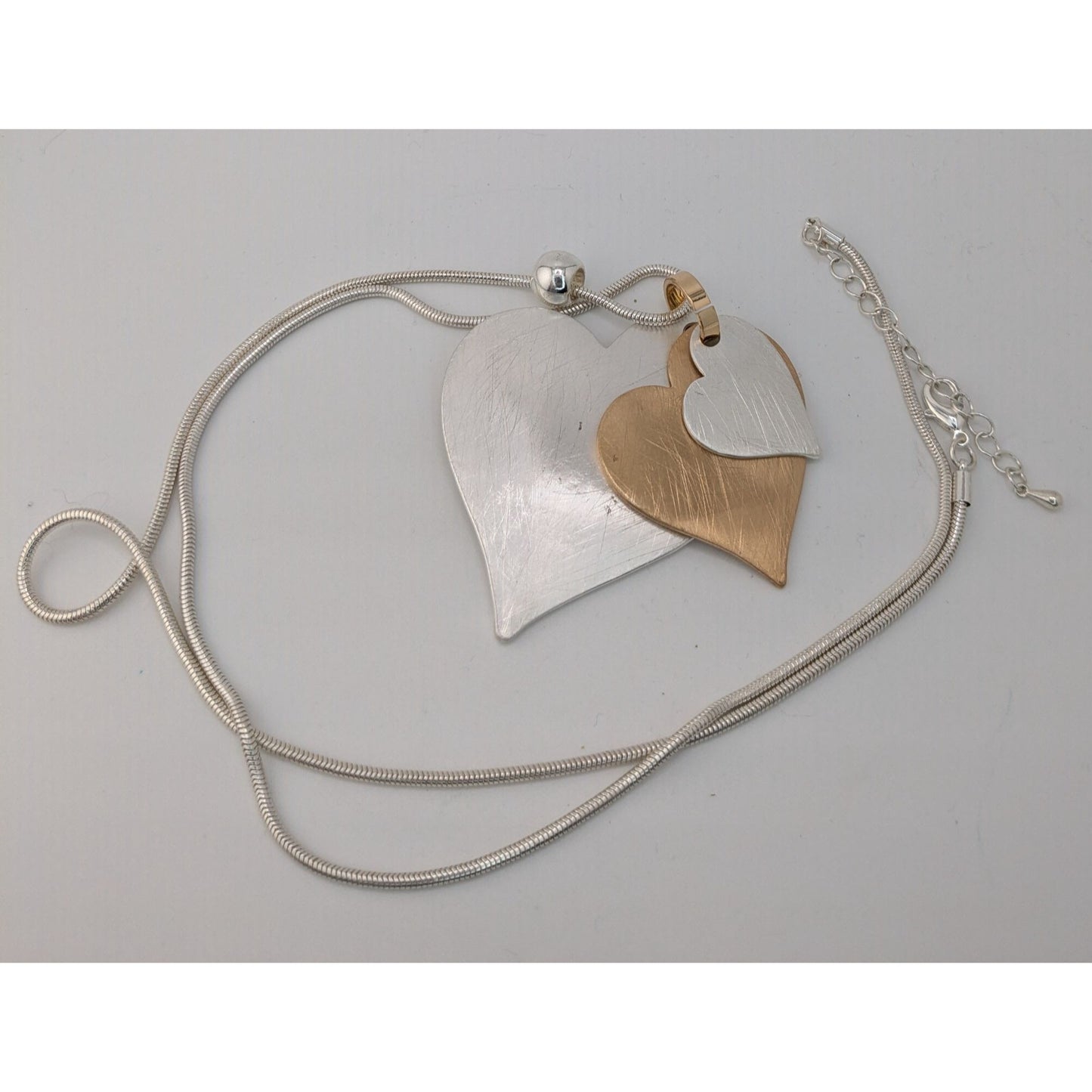 Brutalist Coquette Love Themed Silver & Gold-Tone Layered Heart Pendant Necklace With Snake Chain