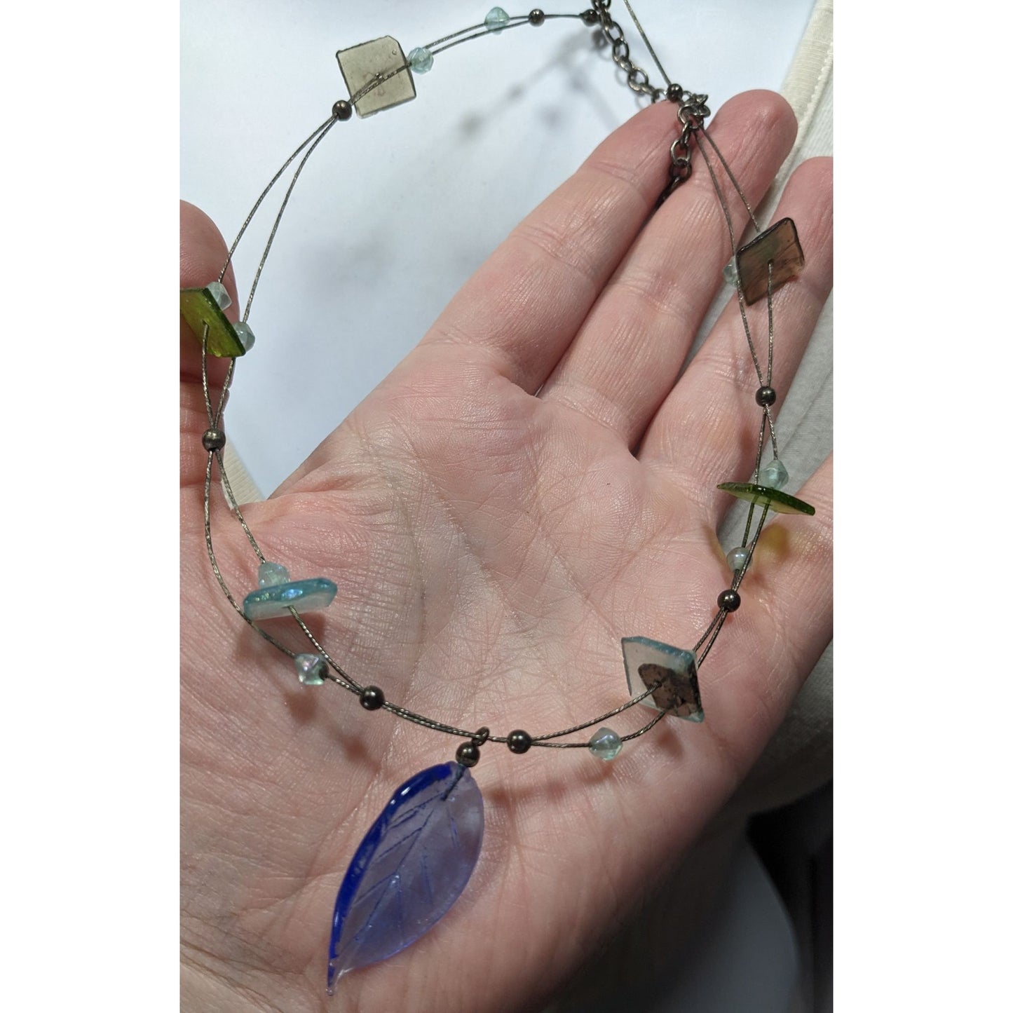 Handcrafted Necklace With Blue Glass Leaf Pendant & Green Accent Beads On Silver Wire Chain