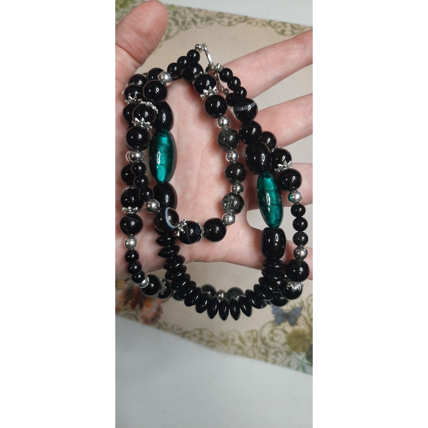 Multi-Strand Black Beaded Necklace With Green Accents & Silver Tone Details