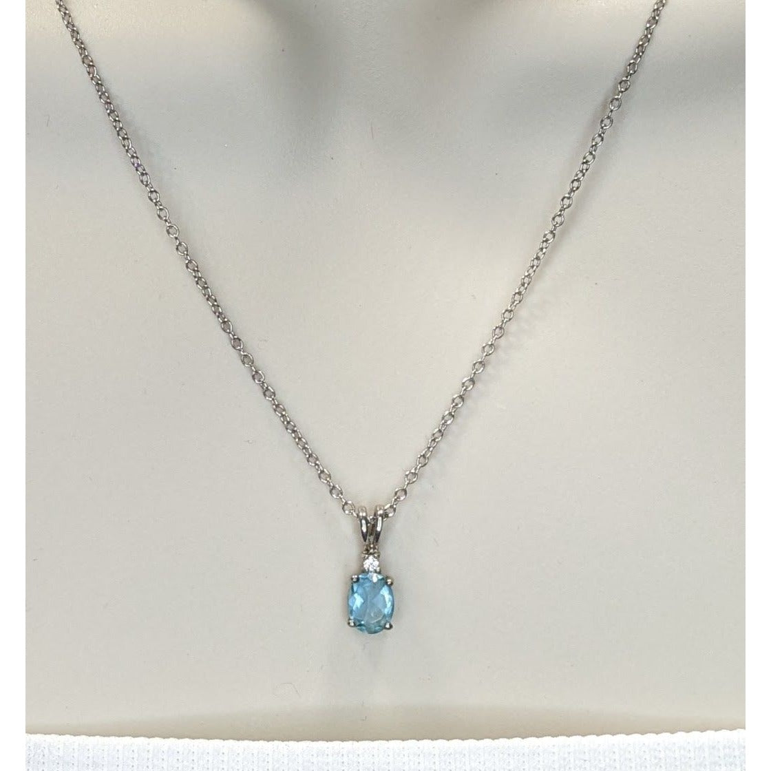 Elegant Silver Tone Necklace With Blue Topaz Oval Pendant And Clear Stone Accent