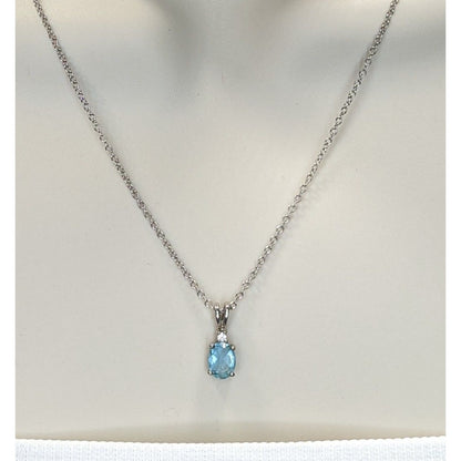 Elegant Silver Tone Necklace With Blue Topaz Oval Pendant And Clear Stone Accent