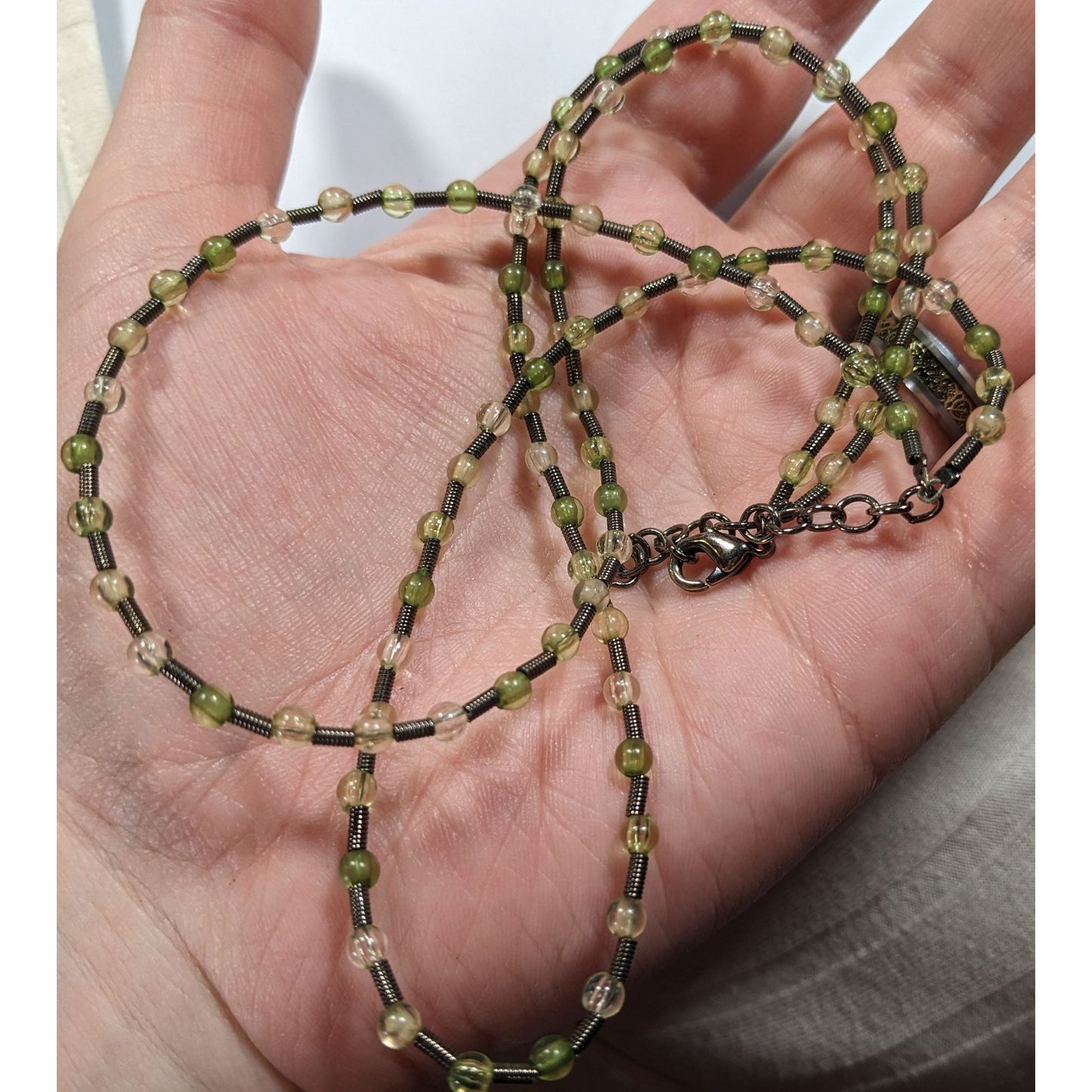 Earthy Clear And Green Glass Necklace With Metal Coil Spacers